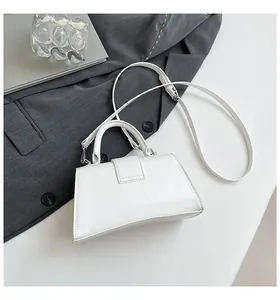 Detail of white glossy hourglass handbag with wrinkled texture and round top handle
