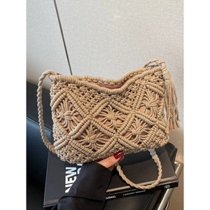 Handwoven hollow knit bucket bag with geometric diamond patterns and tassel in beige