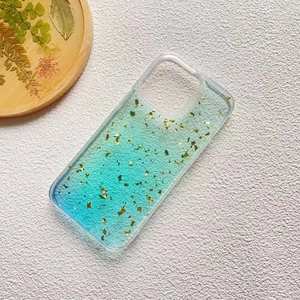 Close-up of clear iPhone case with blue-green gradient resin and embedded gold foil flakes