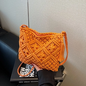 Chic orange knit bucket bag with hollow woven texture and tassel strap for women