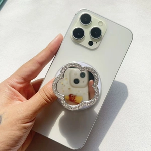 Detailed view of luxury flower shape crystal mirror phone grip on a smartphone back