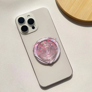 Detail of heart-shaped glitter phone socket with pink and blue sequins on a smartphone