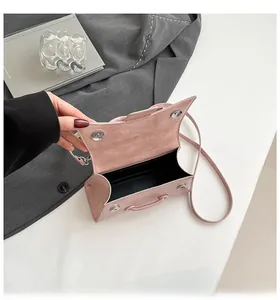 Detailed view of pink leather handbag with magnetic snap closure and textured finish
