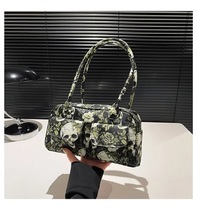 Detail of gothic shoulder bag with skull and vintage green rose prints and front pockets