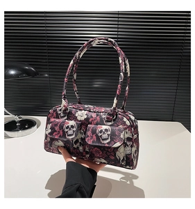 Close-up of gothic floral handbag with skull and rose print and functional front pockets
