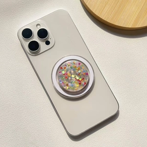 Macro detail of round phone socket holder with colorful glitter heart-shaped sequins