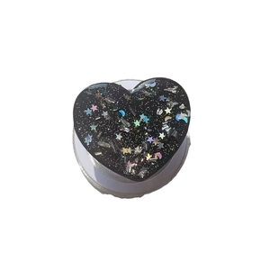 Black glitter heart MagSafe phone grip with holographic stars and moon decorations