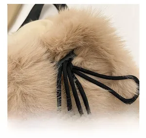Detail of khaki plush backpack showing the black drawstring and adjustable buckle