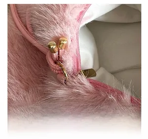 Detailed close-up of pink faux fur texture and a light gold zipper head for luxury bags