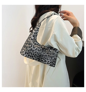 Detailed close-up of metallic leopard print texture on casual crescent hobo bag