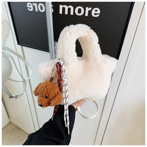 Detail of white plush bucket bag with cute brown poodle pendant and woven knot detail