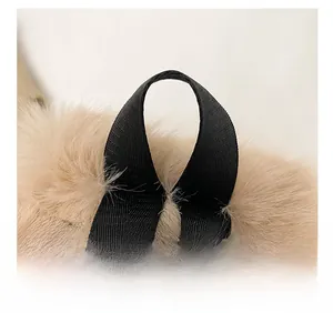 Close-up of comfortable black woven handle and plush faux fur texture of the handbag
