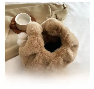 Detail view of plush dumpling bag interior with pearl and white faux fur ball decor
