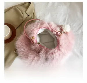 Top view of open pink faux fur handbag showing white fabric interior and plush texture
