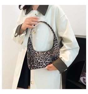 Fashionable leopard print hobo bag worn by model to show size and stylish fit