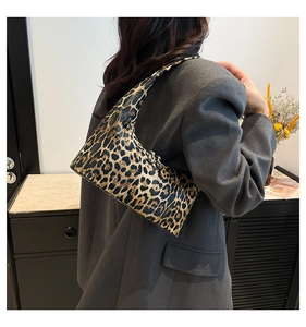 Chic leopard print underarm bag shown on model with professional office attire