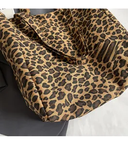 Close-up of leopard print canvas tote bag showing thick twill fabric texture and strap