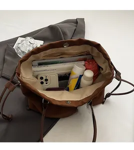 Macro shot of spacious inner compartment of the brown tote bag filled with daily essentials