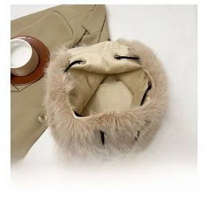 Close-up of the spacious interior and drawstring closure of this khaki plush bucket bag