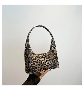 Detail of leopard print hobo bag showing the zipper closure and textured material