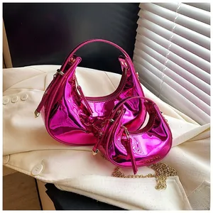Detail of magenta crescent handbags in two sizes with metallic finish and gold chains