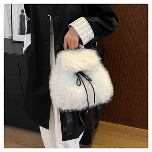 Detailed macro view of white plush backpack with black drawstring and leather straps