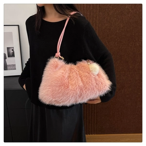 Detailed close-up of pink faux fur shoulder bag texture with fluffy white ball charm