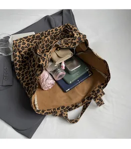 Interior view of leopard print canvas tote bag showing large capacity for daily items
