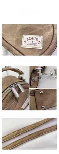 Detail view of brown fabric mummy bag with dual metal zippers and durable strap