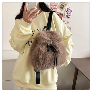 Back view of plush brown faux fur backpack featuring adjustable nylon straps and drawstring