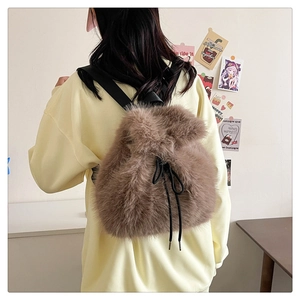 Detail of light brown plush backpack featuring fluffy faux fur and drawstrings