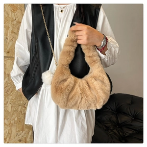 Detail of soft camel plush hobo bag with elegant faux fur texture and gathered folds