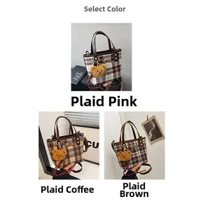 Close-up of three plaid handbags in pink, coffee, and brown with cute bear plush charms
