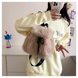 Close-up of soft plush drawstring backpack with fluffy texture and thin black straps