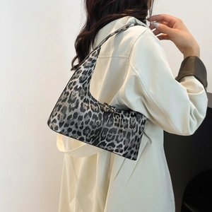 Leopard print bucket bag with metal bows and stylish underarm tote silhouette