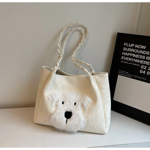 Detail of off-white tote bag with 3D plush puppy dog head and woven textured handles