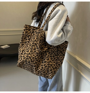 Close-up of leopard print canvas tote bag showing the large capacity and shoulder strap