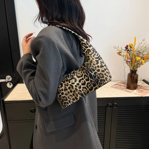Fashionable leopard print bucket tote bag worn by a model in a modern stylish setting