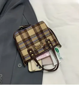 Detail showing internal storage capacity of the plaid wool bag with dog embroidery