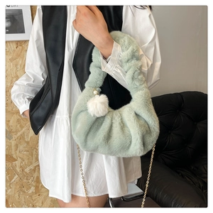 Detail of light green faux fur dumpling bag with gold chain and plush pearl charm