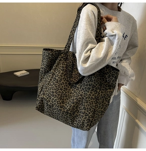Detailed view of oversized leopard print canvas tote bag styled on a female model
