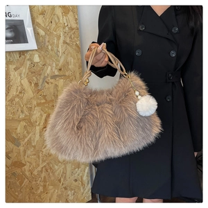 Detail of faux fur tote bag with pearl charm and knotted leather handle in brown