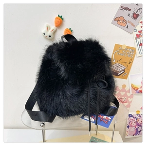 Detail of black faux fur backpack with drawstring closure and cute plush accessories