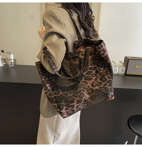 Detailed view of the large capacity leopard print canvas tote bag on a modern counter