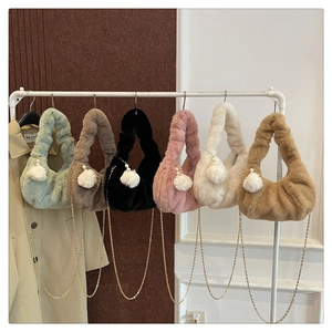 Detail of plush dumpling bags with gold metal chain and pearl ball pendants in six colors