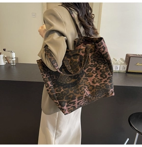 Close-up of leopard print canvas tote bag with spacious interior and dual handles