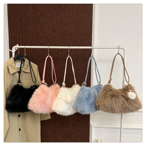 Detailed display of five colorful faux fur shoulder bags with matching fur ball charms