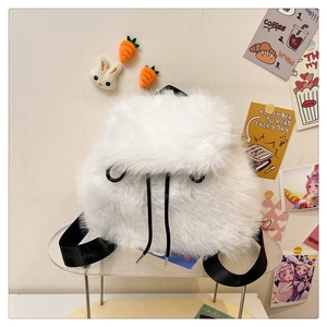 Detailed view of white plush backpack with black drawstrings and woven straps
