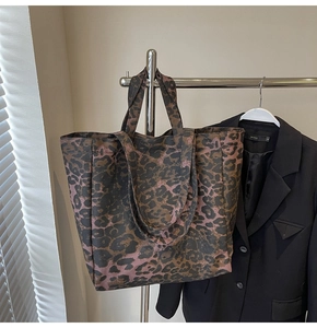 Detail of large leopard print canvas tote bag showing texture and spacious design