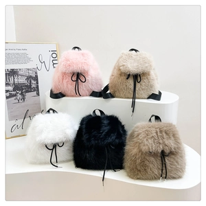Detail showing five colors of mini faux fur backpacks with drawstring bow accents